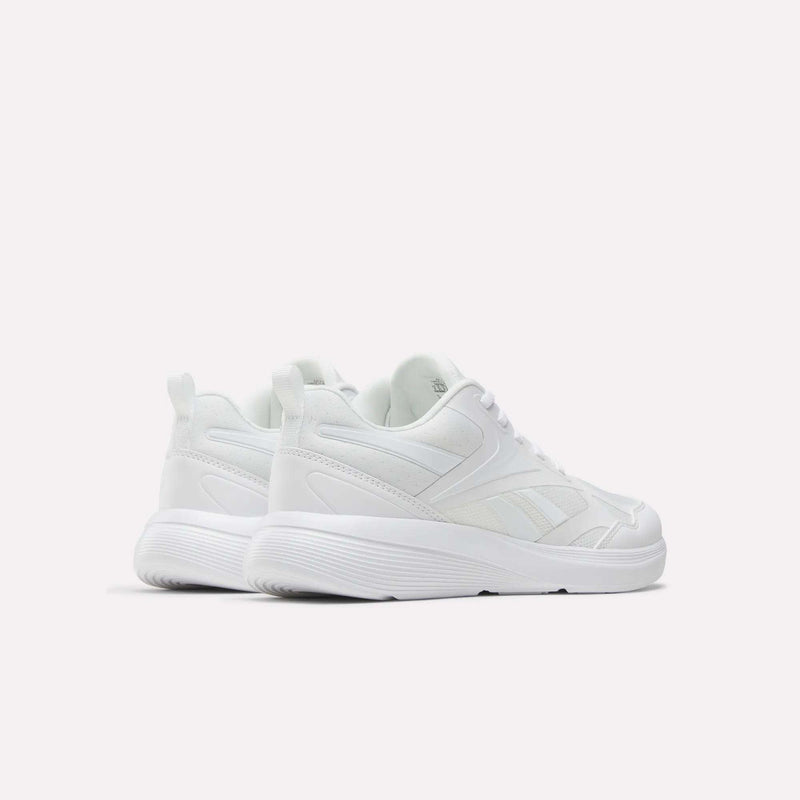 The Reebok Rush Runner 6.0 Running Shoes for big kids are white athletic sneakers with lace-up fronts, EVA midsoles, and textured soles, displayed on a plain white background to show their sides and backs.