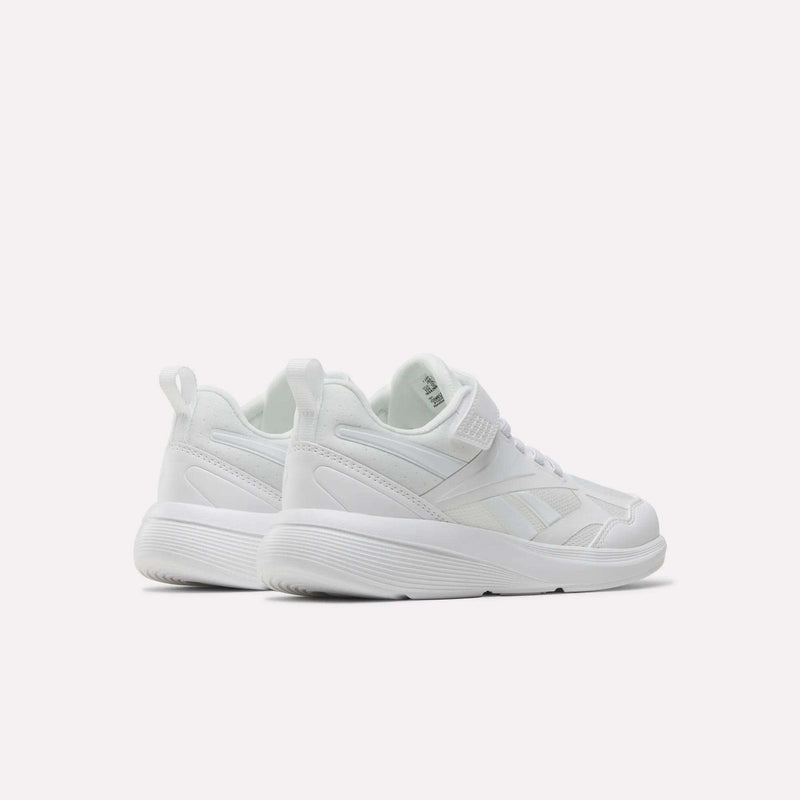 The Reebok Rush Runner 6.0 Elastic Lace Top Strap Running Shoes for little kids are white with thick soles, mesh and leather details, pull tabs at the back, and are designed for all-day comfort—displayed on a plain white background.