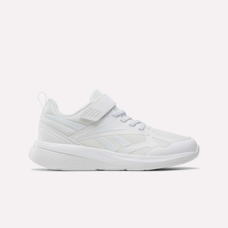 The Reebok Rush Runner 6.0 Elastic Lace Top Strap Running Shoes for little kids feature a white design with mesh and synthetic overlays, a hook-and-loop strap, low profile, and textured sole—shown side view on white. Ideal kids' running shoes.