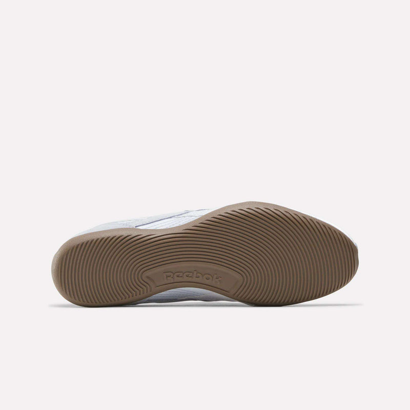 Bottom view of Reebok Women's Ultra Lo Mary Jane Shoes featuring a textured, light brown rubber sole with the Reebok logo at the center, set against a plain white background—an elegant update on classic style.