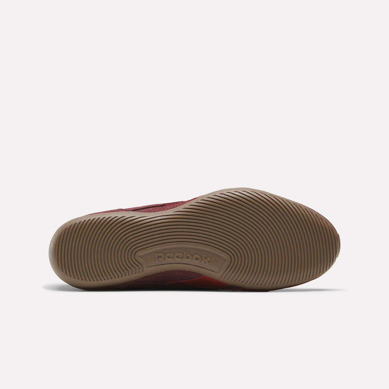 The image displays the sole of a Reebok Women’s Ultra Lo Mary Jane shoe, as seen from the bottom. The light brown sole features a wavy, textured pattern with the Reebok logo embossed in the center. The background is plain white.