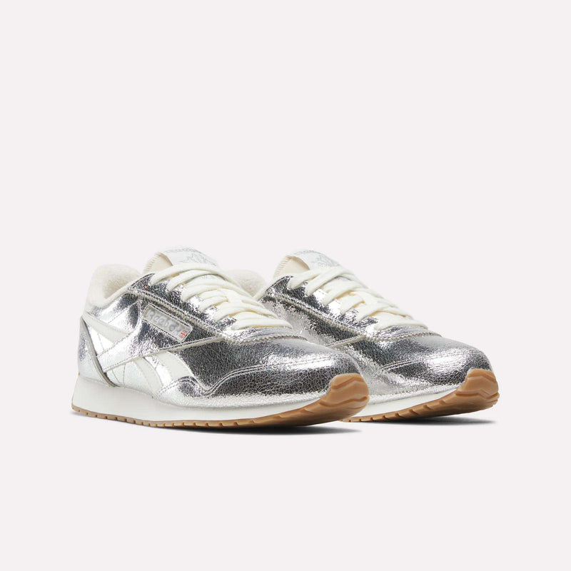 Women’s Classic AZ Shoes by Reebok, featuring silver metallic uppers with white accents and gum soles, displayed on a plain light background.