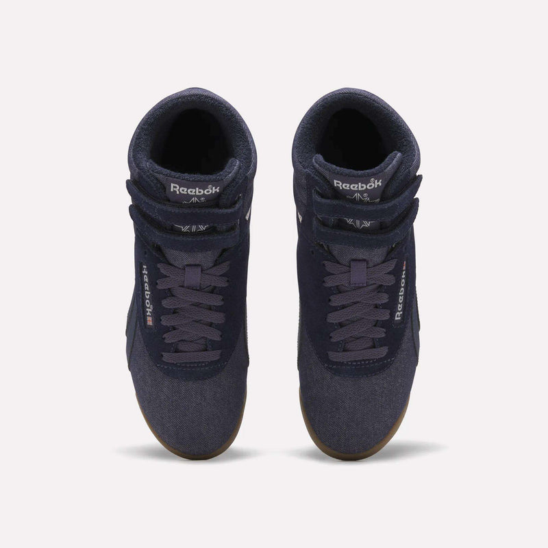 A pair of Reebok Women’s Freestyle Hi Shoes in navy blue, featuring white logos and gum soles, displayed from a top view on a plain light background.