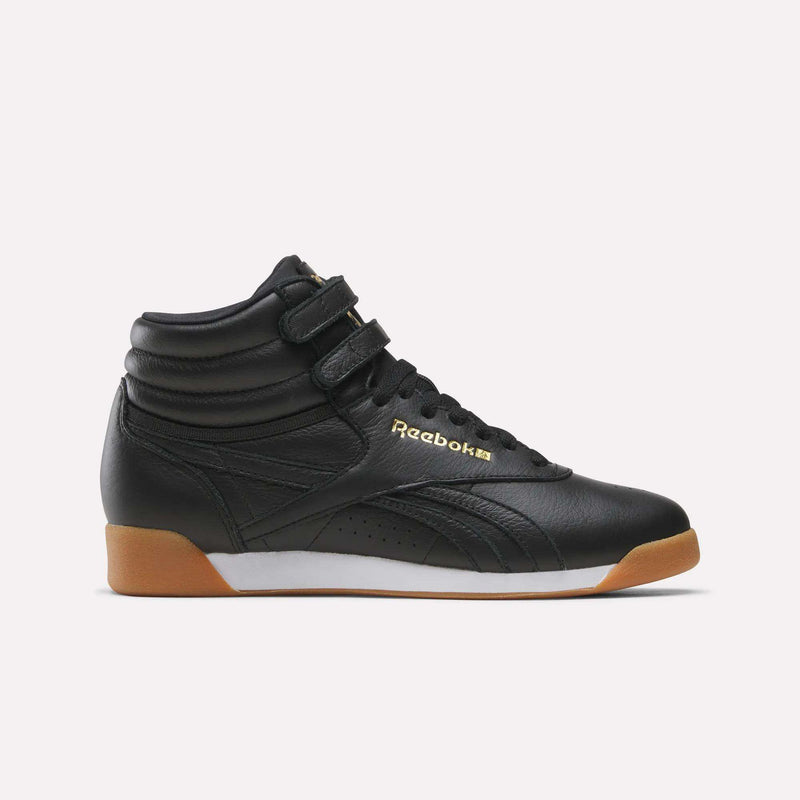 Women’s Freestyle Hi Shoes in black with two ankle straps, gold branding on the side, and a gum rubber sole.