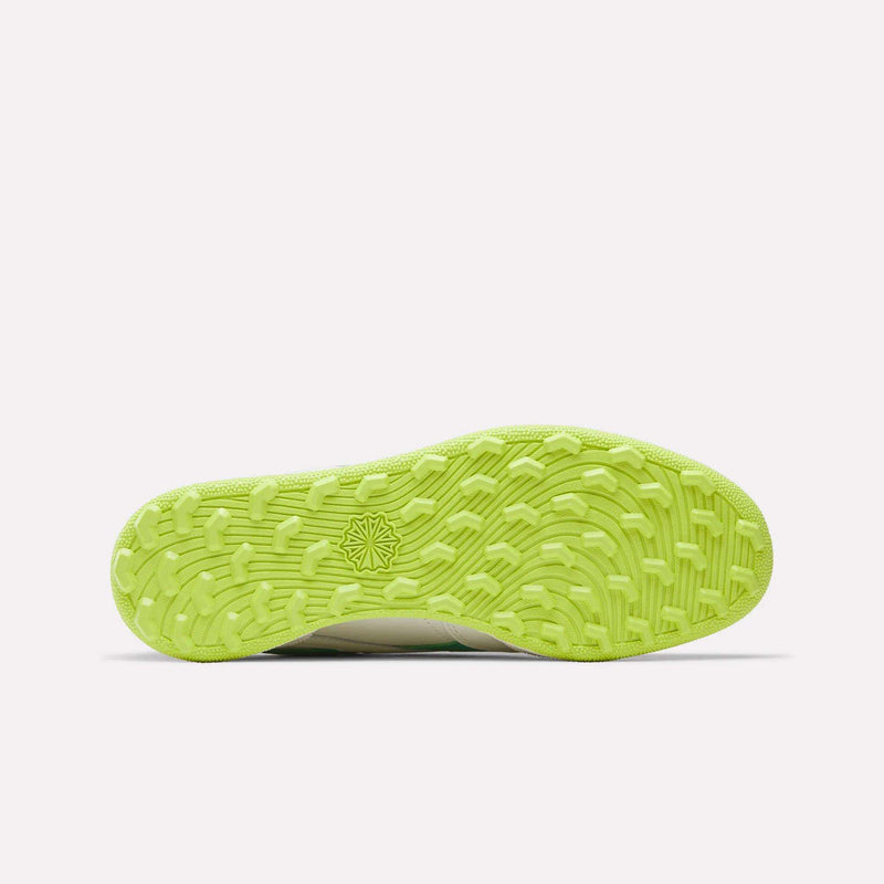 The bright neon green spikeless outsole of a Reebok Men’s Club C Revenge Golf Shoe.