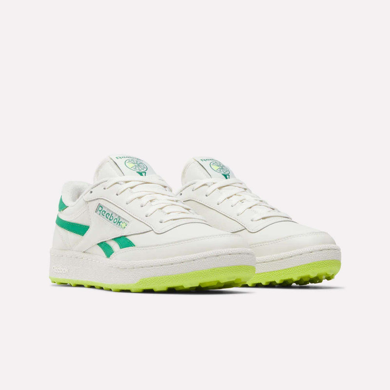 Reebok Men’s Club C Revenge Golf Shoes in off-white with green side stripes and a textured neon yellow spikeless outsole.