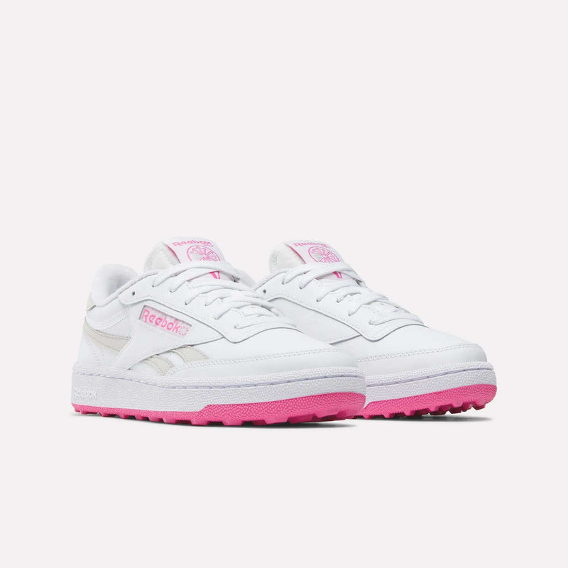A pair of Reebok Women’s Club C Revenge Golf Shoes in white, featuring pink soles and pink Reebok logo accents on the sides and tongue, displayed against a plain light background.