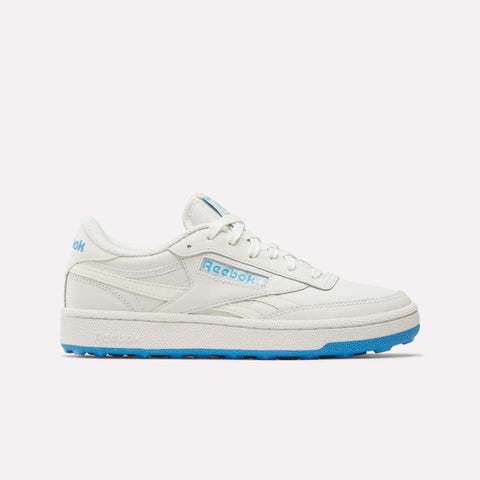 The Reebok Women’s Club C Revenge Golf Shoes in Chalk/Vintage Chalk/Always Blue feature a low-profile white design with eye-catching blue accents on the logo and tongue, plus a vibrant blue sole. Displayed on a plain white background, these stylish women’s golf shoes are ideal for comfort both on and off the course.