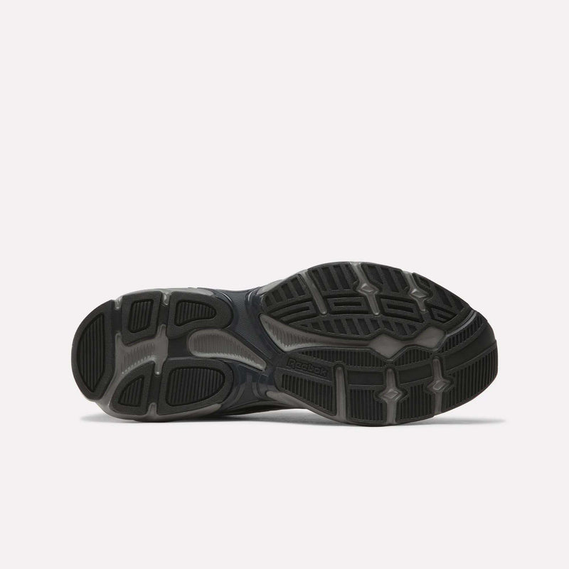 The image features the black and gray rubber sole of the Reebok Premier Road 1000 Shoes, viewed from below, highlighting its tread pattern and grip details against a plain white background—a signature element of classic retro running footwear.