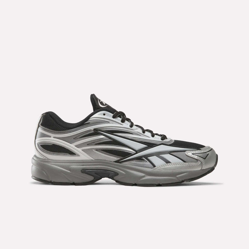The Reebok Premier Road 1000 Shoes in Black/Silver/Grey4 are athletic sneakers inspired by Y2K designs, featuring black laces and a thick, cushioned sole, shown on a plain white background.