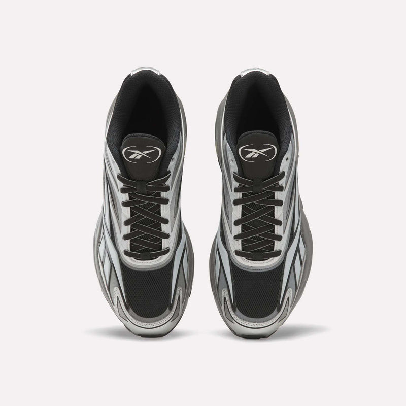 A pair of Reebok Premier Road 1000 Shoes in black, white, and gray are shown from above on a plain white background, featuring black laces and a stylized logo on each tongue—these retro athletic sneakers embody early 2000s design.