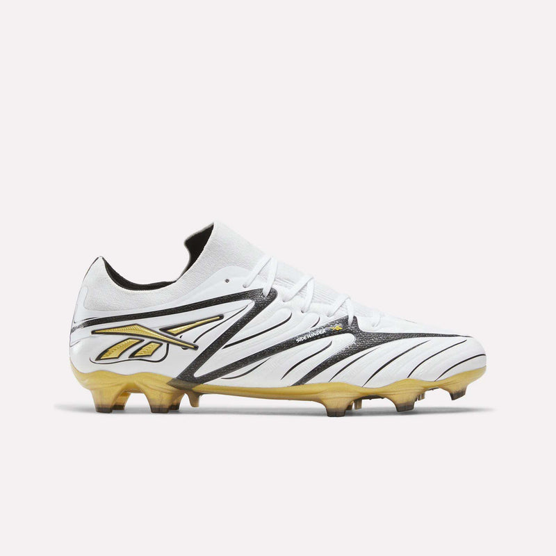 The Sidewinder 26 Elite Firm Ground Cleats by Reebok come in a white, black, and silver color scheme, featuring the signature Reebok logo and detailing in black. Designed for firm ground play with a durable sole and molded studs, these soccer cleats are engineered to enhance ball control. Shown against a plain white background.