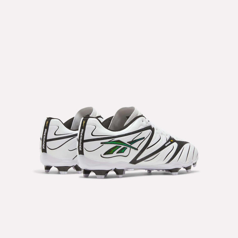 A pair of Reebok Sidewinder 26 League Firm Ground Cleats in white with black and green accents, shown from the back and side to highlight their firm ground studs for improved traction, displayed against a plain white background.