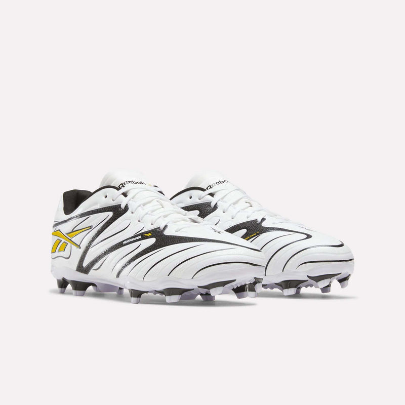 White Reebok Sidewinder 26 League Firm Ground Cleats with black accents and a yellow logo.