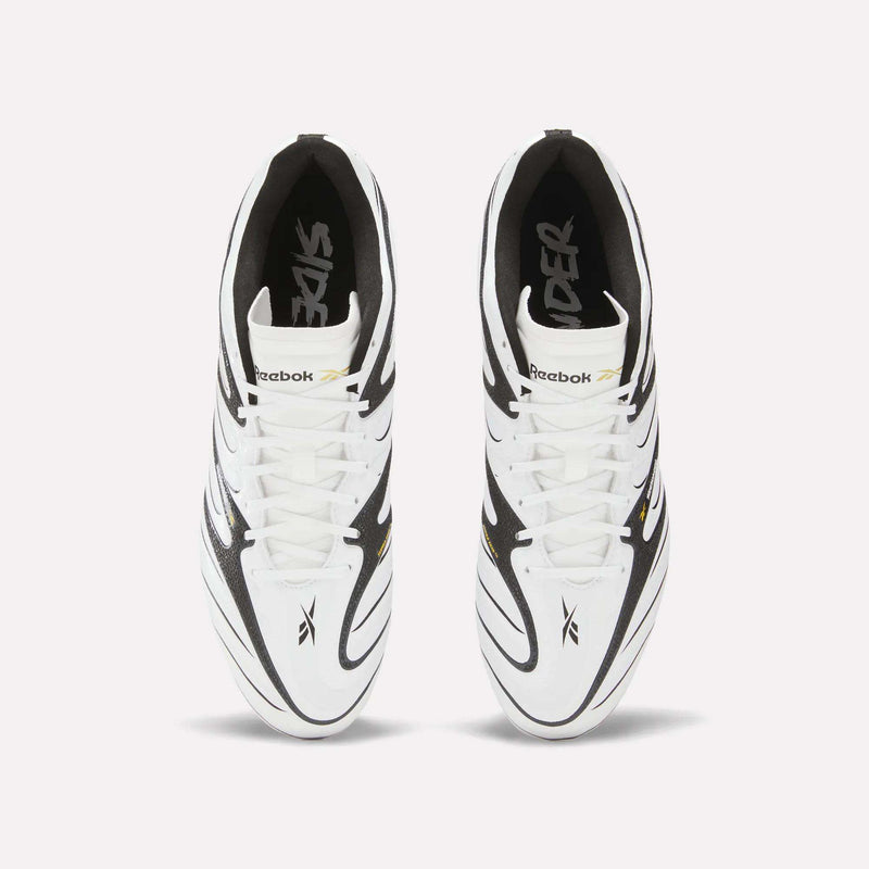 Top view of a pair of Reebok Sidewinder 26 League Firm Ground Cleats in white with black and gold accents, featuring firm ground studs for superior ball control. The cleats have black laces and display the Reebok logo on the tongue and sides, set against a plain white background.