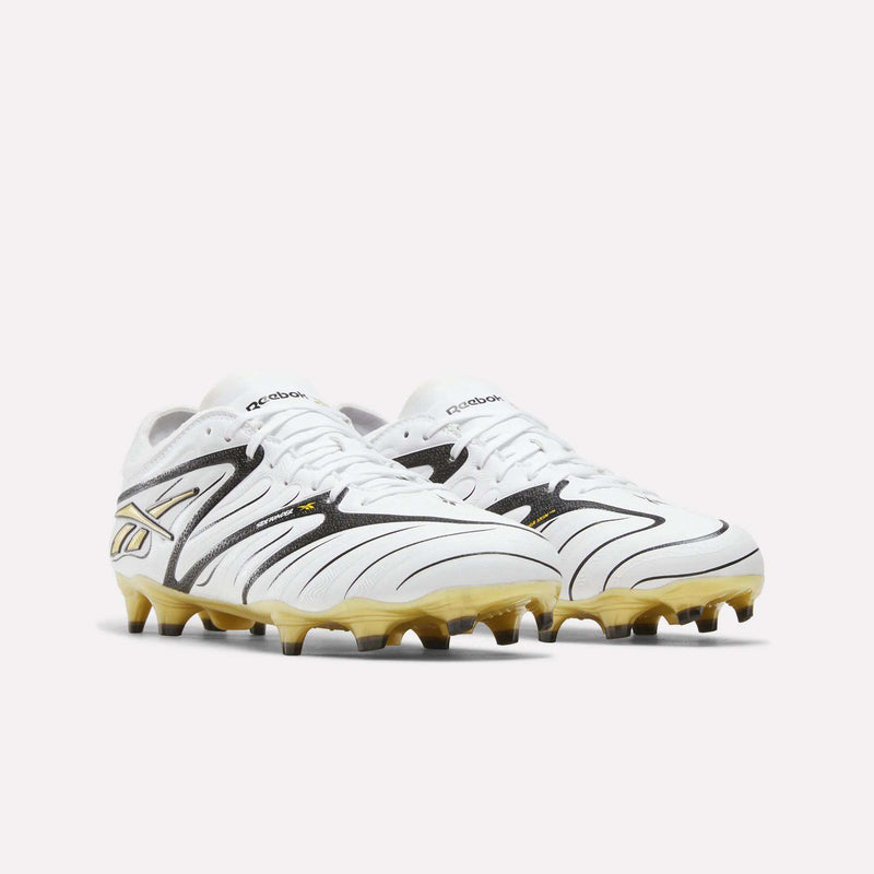 A pair of Reebok Sidewinder 26 Pro Firm Ground Cleats in white and gold with black accents, positioned side by side on a plain white background.