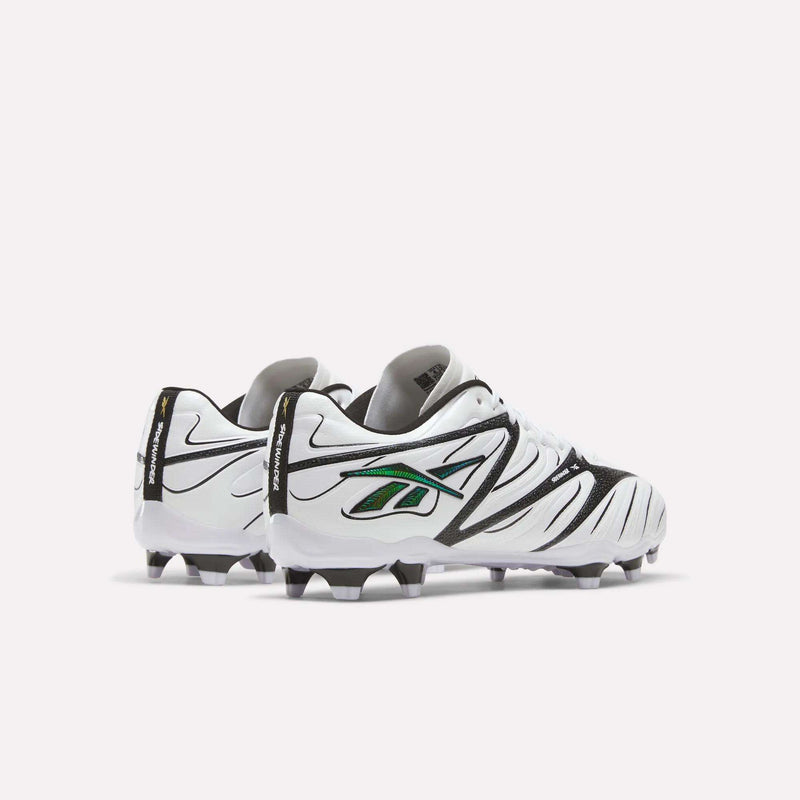 A pair of Reebok Sidewinder 26 League Firm Ground Cleats for big kids in white with black and green accents, featuring firm ground studs and shown slightly angled apart on a plain white background.