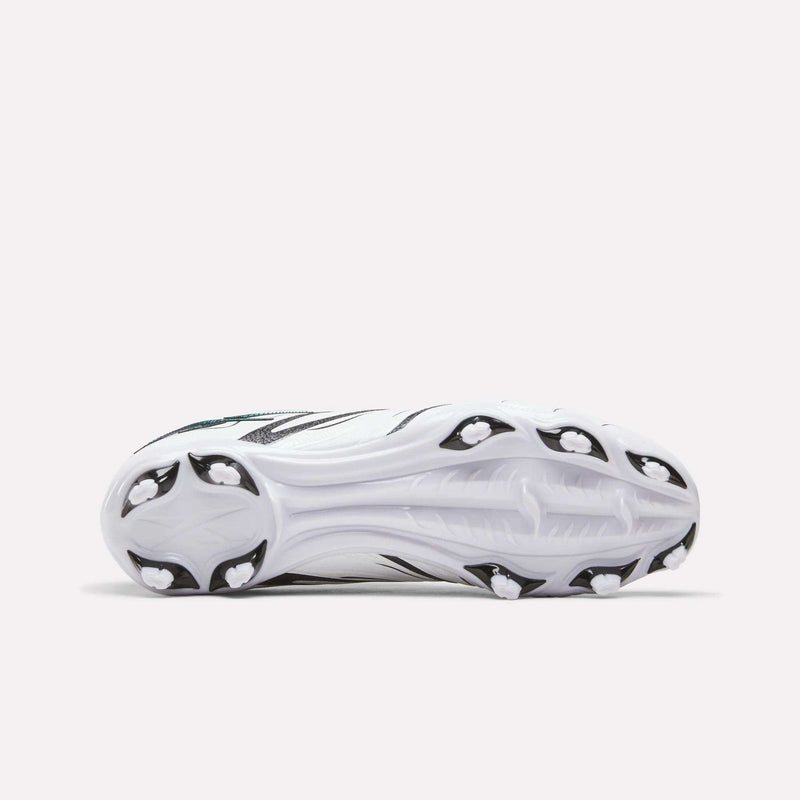 The image shows the bottom view of the Reebok Sidewinder 26 League Firm Ground Cleats for big kids, featuring a white design with black accents and firm ground studs for optimal traction on athletic fields.
