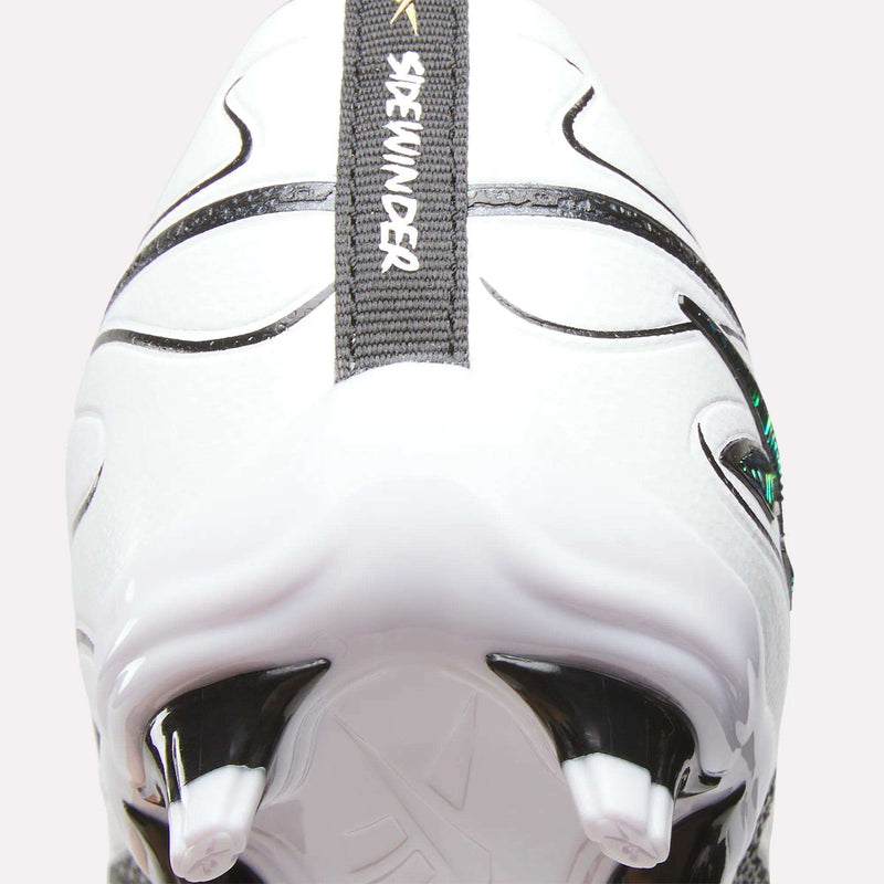 Close-up of the heel and firm ground studs of a white Reebok Sidewinder 26 League Firm Ground Cleat for big kids, featuring black and gray details. A SKYHUNTER text appears on a gray strip running vertically up the shoe’s back, highlighting the precision design characteristic of kids’ Reebok cleats.