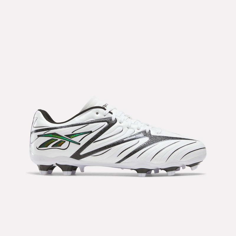 The Reebok Sidewinder 26 League Firm Ground Cleats for big kids are shown in a white, black, and silver colorway, featuring black side patterns and molded studs designed for firm ground play, set against a plain light background.