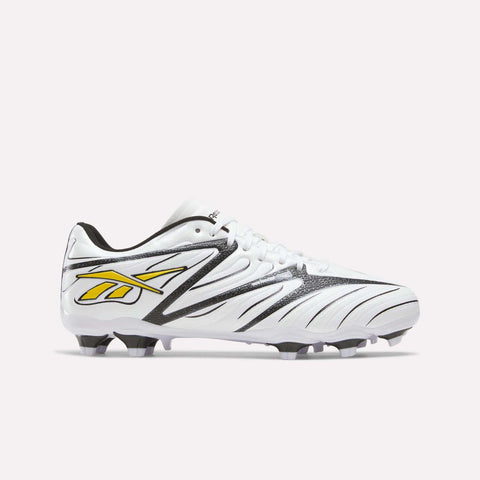 White Reebok Sidewinder 26 League Firm Ground Cleats for big kids, featuring black accents, a yellow logo on the side, and firm ground studs.