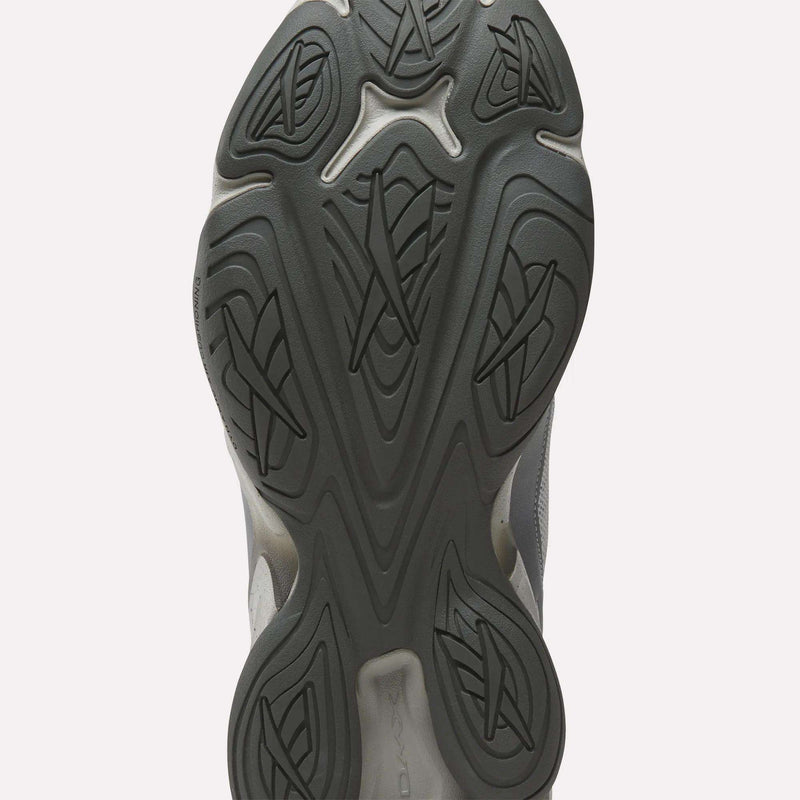 Close-up of the black rubber outsole on the Reebok Mita Sneakers x DMX Series 3000 Shoes, showing an intricate pattern of curved lines and geometric shapes for traction, enhanced with Reebok’s DMX moving air technology.