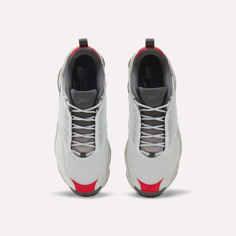 A pair of white Reebok Mita Sneakers x DMX Series 3000 athletic shoes with gray soles and laces, red accents on the toe and heel, and DMX moving air technology, seen from above on a white background.