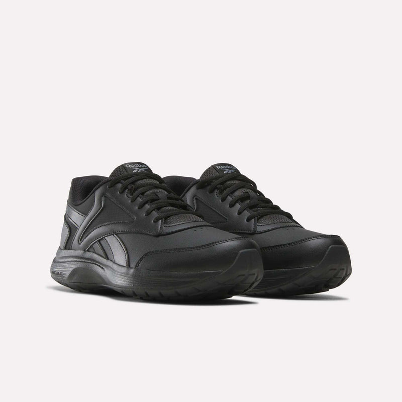 A pair of Men's Walk Ultra 7 DMX Max Shoes by Reebok in black, featuring matching black laces and soles with DMX cushioning for enhanced comfort, displayed on a white background and angled slightly to the left.