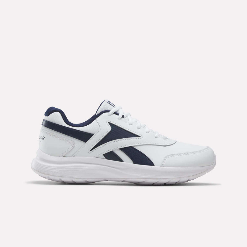 The Men's Walk Ultra 7 DMX Max Shoes by Reebok are shown from the side on a plain light background, featuring a white design with Collegiate Navy and Collegiate Royal accents and a thick sole. These men's shoes come equipped with DMX cushioning for superior comfort, making them an excellent choice for cushioned everyday walking.