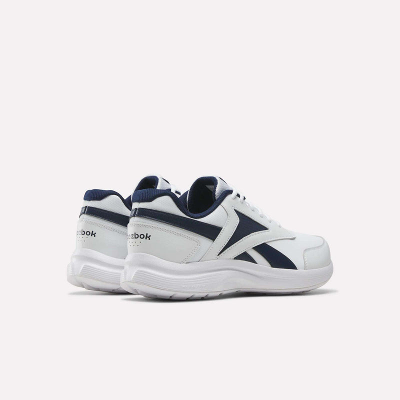 Men's Walk Ultra 7 DMX Max Shoes - Wide 4E by Reebok in white with navy blue accents and logo, featuring DMX cushioning for enhanced comfort. Displayed on a plain white background, these wide-fit walking shoes are angled to highlight both the side and back views.