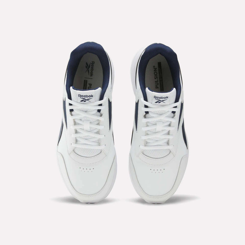 A pair of Men's Walk Ultra 7 DMX Max Shoes - Wide 4E by Reebok in white with navy accents, shown from above. These shoes feature white laces, perforated toe areas, DMX cushioning for enhanced comfort, and Reebok branding on the tongues and insoles.