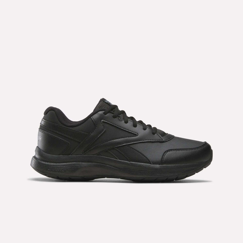 A side view of the Reebok Men's Walk Ultra 7 DMX Max Shoes - Wide 4E in Black/Cold Grey 5/Collegiate Royal is displayed on a plain white background, showcasing its lace-up design, low-cut profile, and textured sole with DMX cushioning for enhanced comfort.