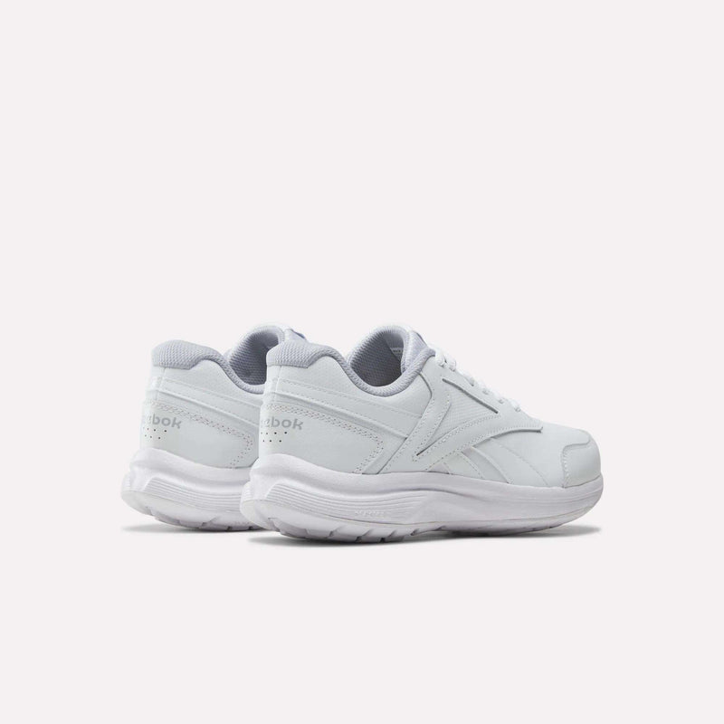 A pair of Reebok Women’s Walk Ultra 7 DMX Max Shoes in white with gray accents, seen from the rear left side, display the Reebok logo on the heel and feature a textured sole—these walking shoes are engineered for all-day comfort.