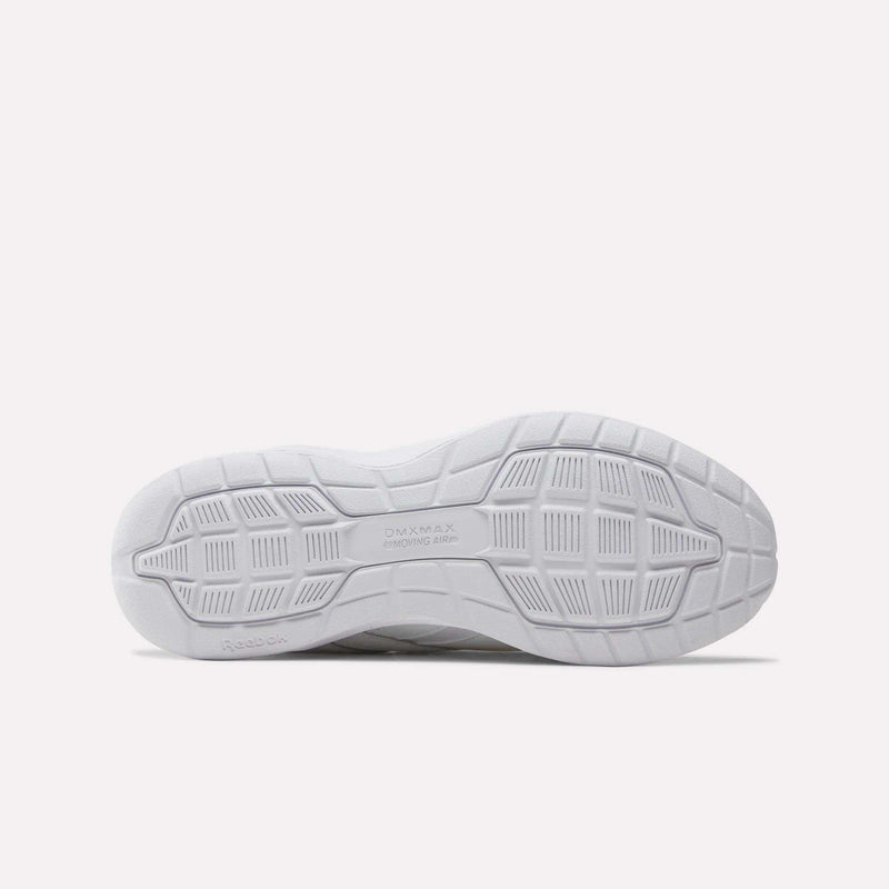 The image displays the white outsole of the Women’s Walk Ultra 7 DMX Max Shoes by Reebok, featuring a textured grid and geometric tread pattern designed for all-day comfort. Both the Reebok brand name and “DMXMAX Moving Air” text are visible on the sole. The background is plain light grey.