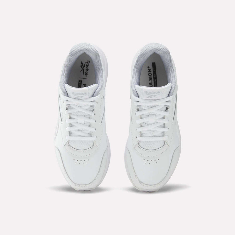 Top view of a pair of Reebok Women’s Walk Ultra 7 DMX Max shoes in white, featuring laces, perforated toe areas, and visible Reebok logos on the tongues. These cushioned walking shoes are placed side by side on a light background and are designed for all-day comfort.