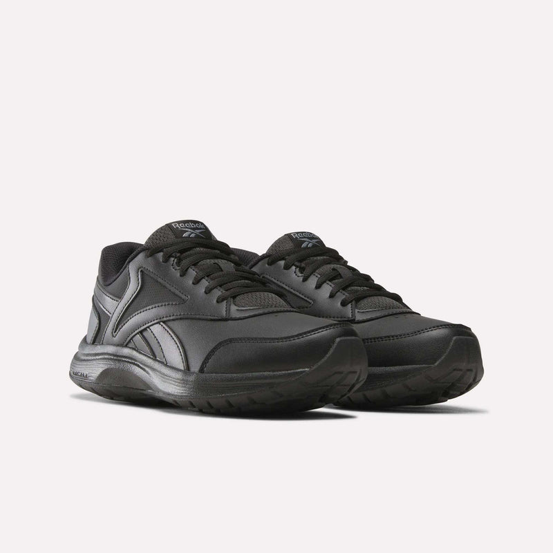 A pair of Reebok Women’s Walk Ultra 7 DMX Max Shoes in black, featuring a low-top silhouette, lace-up closure, and textured soles, presented against a plain white background. Designed with cushioning for all-day comfort, these walking shoes are perfect for everyday wear.