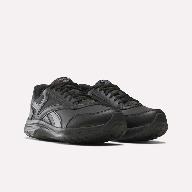 A pair of Reebok Women’s Walk Ultra 7 DMX Max Shoes in a wide D fit, featuring black athletic design with matching black laces and textured rubber soles for all-day walking comfort, displayed on a plain light background.