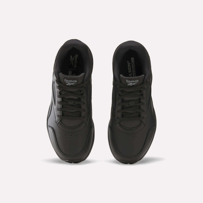 A pair of black Women’s Walk Ultra 7 DMX Max Shoes - Wide D by Reebok are placed side by side on a light background, viewed from above, displaying the laces, tongues featuring Reebok logos, and perforated toe boxes—designed for all-day comfort.