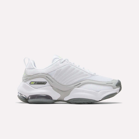 The Reebok Women’s DMX Series 3000 Shoes in White/New Grey 1/Digital Lime feature a mesh upper, thick sole, and DMX moving air technology that delivers visible air cushioning in the heel for ultra-cushioned comfort and lightweight support, shown on a plain white background.
