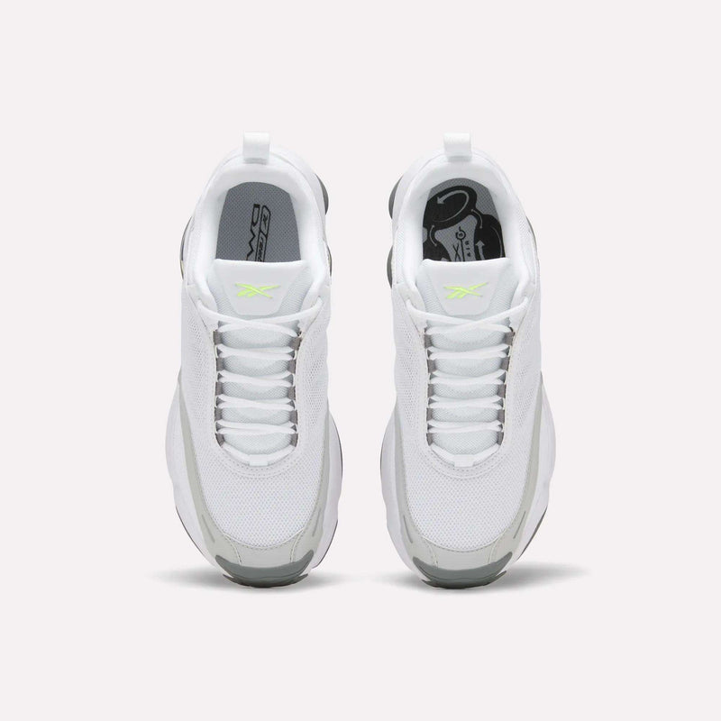 A pair of Reebok Women’s DMX Series 3000 Shoes in white with gray accents and a neon yellow logo, featuring DMX moving air technology for ultra-cushioned comfort and lightweight support, shown from above on a plain white background.
