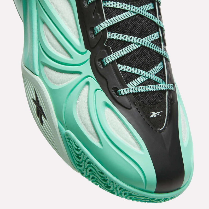 Close-up of a turquoise and black Angel Reese 1 Basketball Shoe with intricate laces, mesh fabric, and a textured sole, showcasing the Reebok logo on the side and tongue. Designed for peak performance basketball enthusiasts, this model features the advanced Reebok Energy Return System for enhanced cushioning and support on the court.