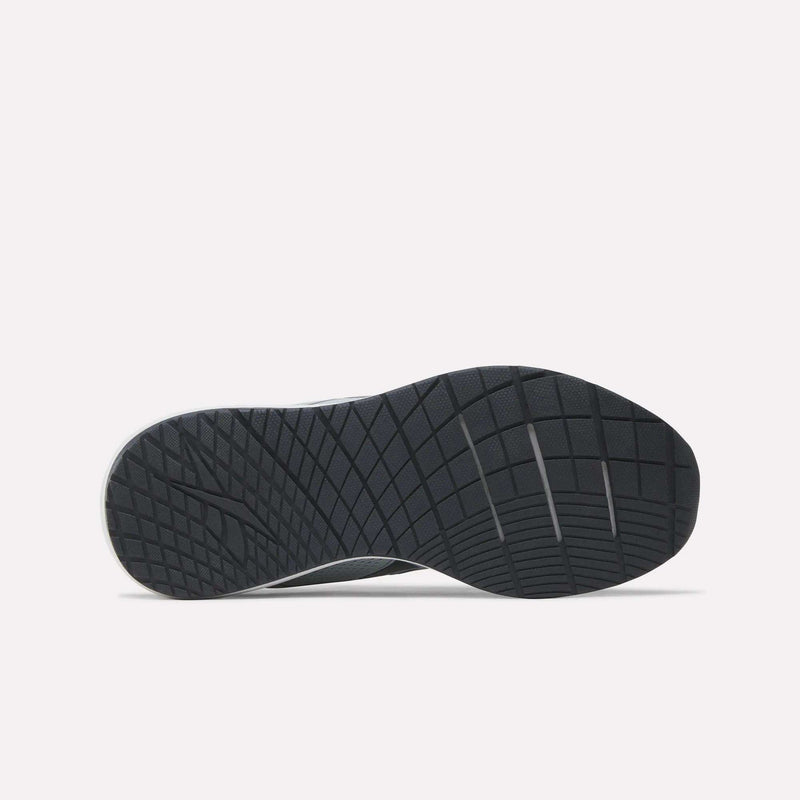The image displays the black rubber outsole of the Reebok Women’s NFX Trainer 2 Training Shoe, viewed from beneath. The tread pattern showcases intersecting diagonal and horizontal lines designed to enhance grip and traction. The shoe is set against a plain white background.