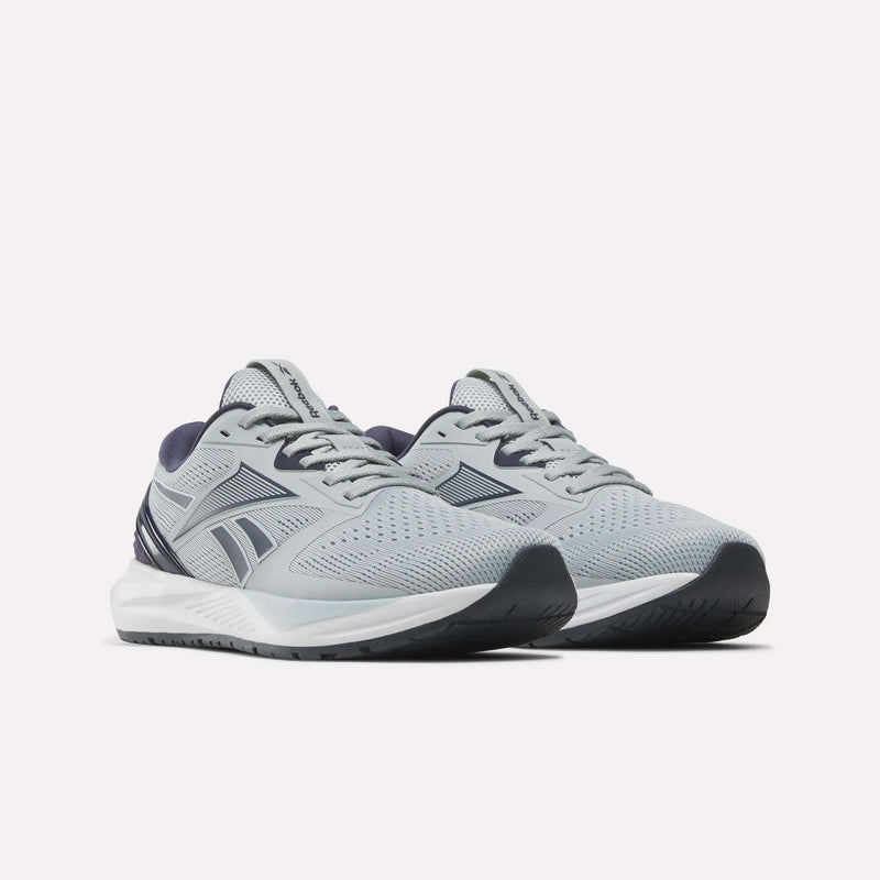 The Reebok Women’s NFX Trainer 2 Training Shoes feature light gray mesh uppers with dark blue accents, white midsoles, and black rubber outsoles, showcased against a plain white background.