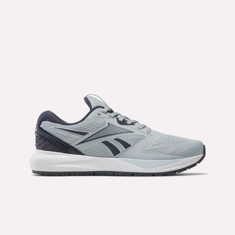 Introducing the Reebok Women’s NFX Trainer 2 Training Shoes—shown in a sleek gray with deep blue accents and a crisp white sole, side-profile on a plain white background. Perfect for gym sessions or as versatile workout footwear.