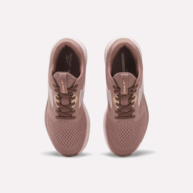 A pair of Reebok Women's Nanoflex 2.0 Training Shoes in pink, shown from above with white side stripes, brown laces, and perforated toes for breathability on a plain white background.