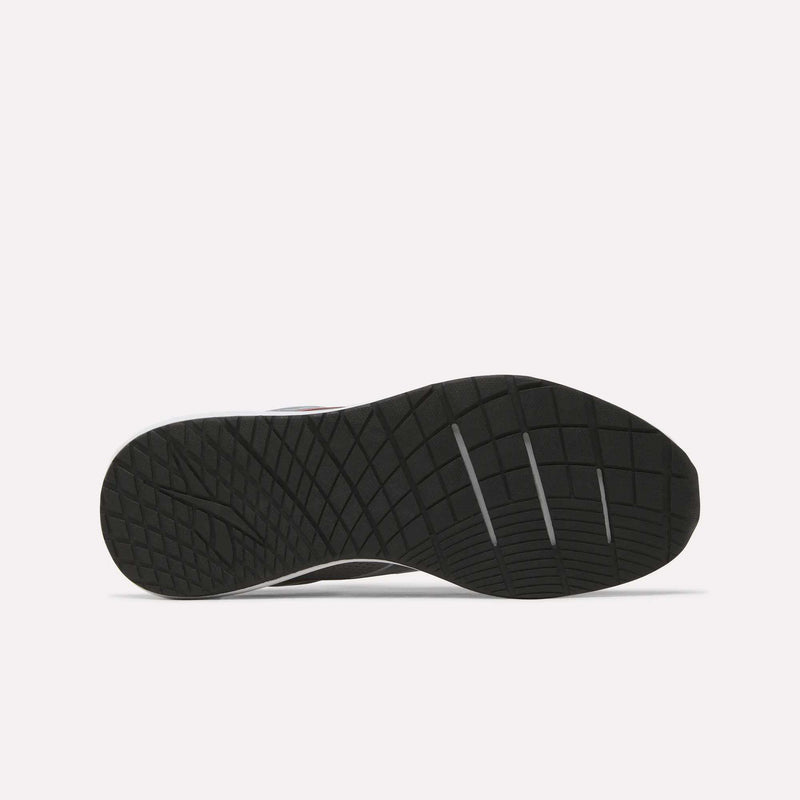 The image displays the black rubber outsole of the Men's Nanoflex 2 Training Shoes by Reebok, featuring a geometric traction pattern and three deep horizontal grooves for enhanced flexibility. The background is plain white.