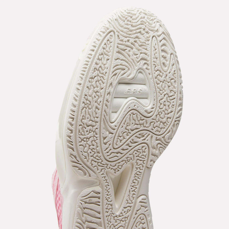 Close-up of the white textured sole on Reebok's Engine A 26 Basketball Shoes, featuring intricate patterns and JUMPMAN embossed at the center; part of the pink and white upper shows off the shoe’s style and stability.