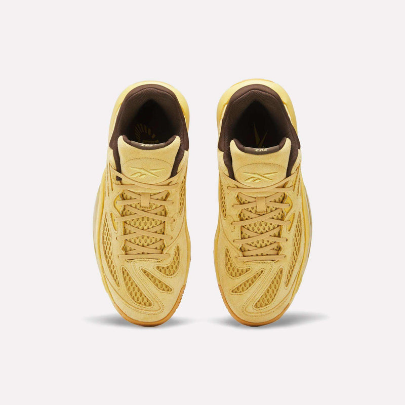 Top view of a pair of Reebok Engine A 26 Basketball Shoes in yellow, featuring brown inner lining and mesh with textured details for added stability, placed side by side on a plain white background.