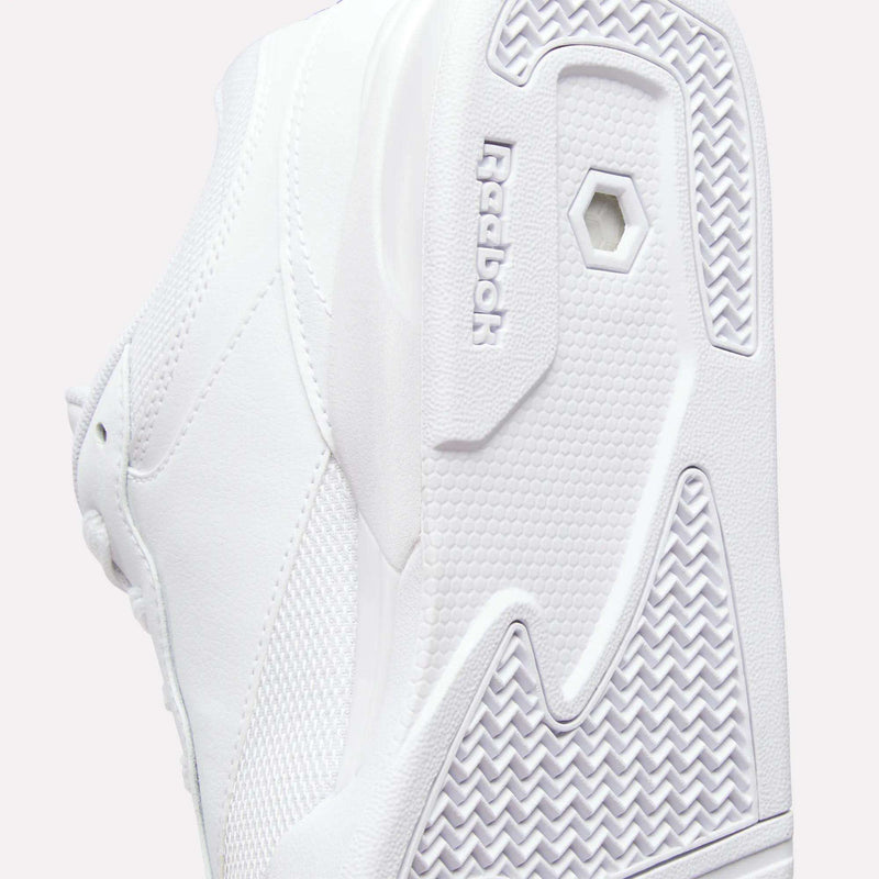 Close-up of the white sole and side of Reebok Omni Edge Shoes, highlighting textured patterns and the embossed Reebok logo near the sole. This retro basketball shoe by Reebok features a premium leather upper for enhanced style and durability.