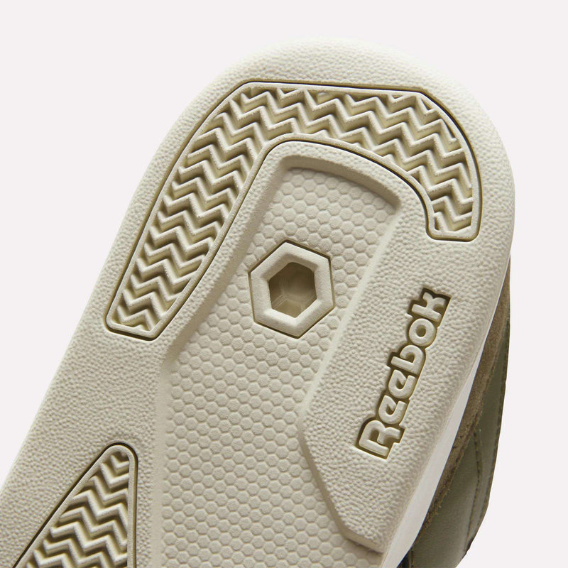 A close-up of the outsole on Reebok Omni Edge Shoes highlights textured patterns, a hexagonal cutout, and the beige rubber Reebok logo—demonstrating the premium design and meticulous detailing inspired by classic basketball court footwear.